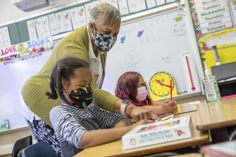 Joy Harrison instructs her second graders as California Gov. Gavin Newsom visits the classroom at Carl B. Munck Elementary School, Wednesday, Aug. 11, 2021, in Oakland, Calif. The governor announced that California will require its 320,000 teachers and school employees to be vaccinated against the novel coronavirus or submit to weekly COVID-19 testing. (Santiago Mejia/San Francisco Chronicle via AP, Pool)