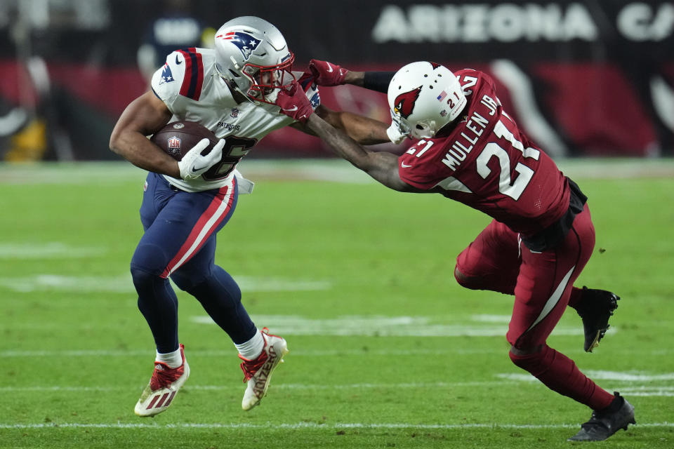 Arizona Cardinals cornerback Trayvon Mullen (21) grabs New England Patriots running back Kevin Harris' face mask during the first half of an NFL football game, Monday, Dec. 12, 2022, in Glendale, Ariz. (AP Photo/Ross D. Franklin)