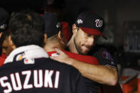 Washington Nationals starting pitcher Max Scherzer (31) is greeted by teammates in the dugout in the middle of the seventh inning in Game 4 of a baseball National League Division Series against the Los Angeles Dodgers, Monday, Oct. 7, 2019, in Washington. (AP Photo/Alex Brandon)