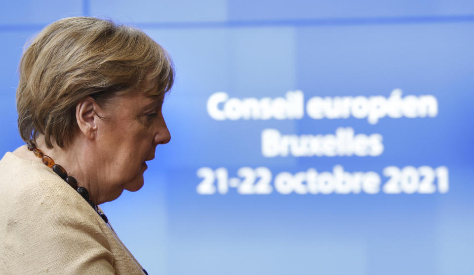 German Chancellor Angela Merkel arrives for an EU summit at the European Council building in Brussels, Thursday, Oct. 21, 2021. European Union leaders head into a standoff between Poland and most of the other EU member nations over the rule of law in the eastern member state. Other issues for the 27 EU leaders include climate change, the energy crisis, COVID-19 developments and migration. (AP Photo/Olivier Matthys, Pool)