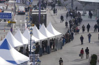 People queue in line to wait for the coronavirus testing at a temporary screening clinic for the coronavirus in Seoul, South Korea, Monday, Nov. 29, 2021. (AP Photo/Lee Jin-man)