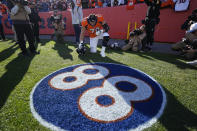 Denver Broncos offensive tackle Garett Bolles (72) kneels at a tribute to former Denver Broncos wide receiver Demaryius Thomas before an NFL football game, Sunday, Dec. 12, 2021, in Denver. (AP Photo/Jack Dempsey)