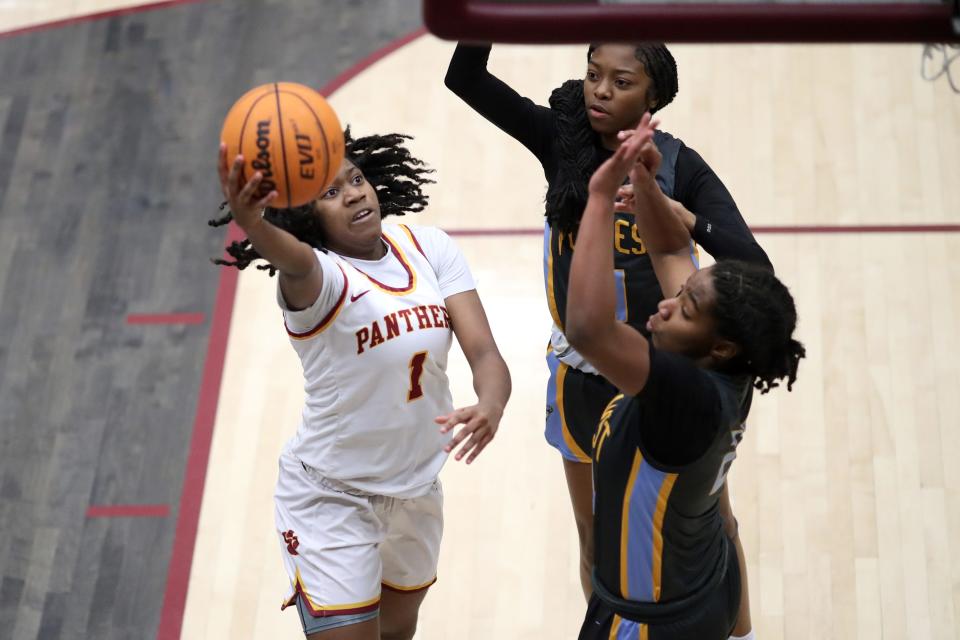 PC North's Nini Geretta puts up a shot beside PC West's Jayla Constant, center, and Da'Nae Jeferson during a girls high school basketball game between Putnam City North and Putnam City West at PC North High School in Oklahoma City, Friday, Feb. 10, 2023. 