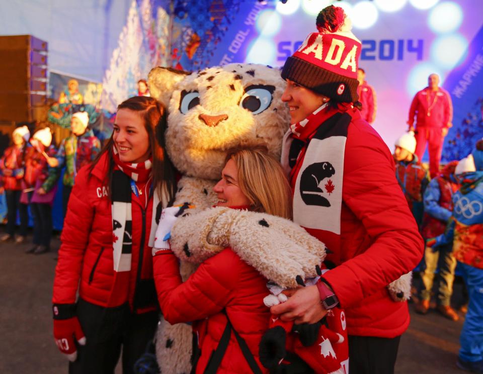 Members of Canada's Olympic Team pose with an Olympic mascot during a welcoming ceremony for the team in the Athletes Village, at the Olympic Park ahead of the 2014 Winter Olympic Games in Sochi February 5, 2014. REUTERS/Shamil Zhumatov (RUSSIA - Tags: SPORT OLYMPICS)