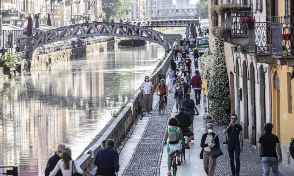 People walk along the popular Navigli area, in Milan, Italy on Friday.