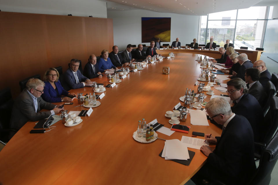 German Chancellor Angela Merkel, fifth from left, leads a meeting of the called Climate Cabinet at the chancellery in Berlin, Germany, Friday, Sept. 20, 2019. The Climate Cabinet in a committee of German government ministers and advisors to develop strategies for Germany to fight the climate change. (AP Photo/Markus Schreiber)