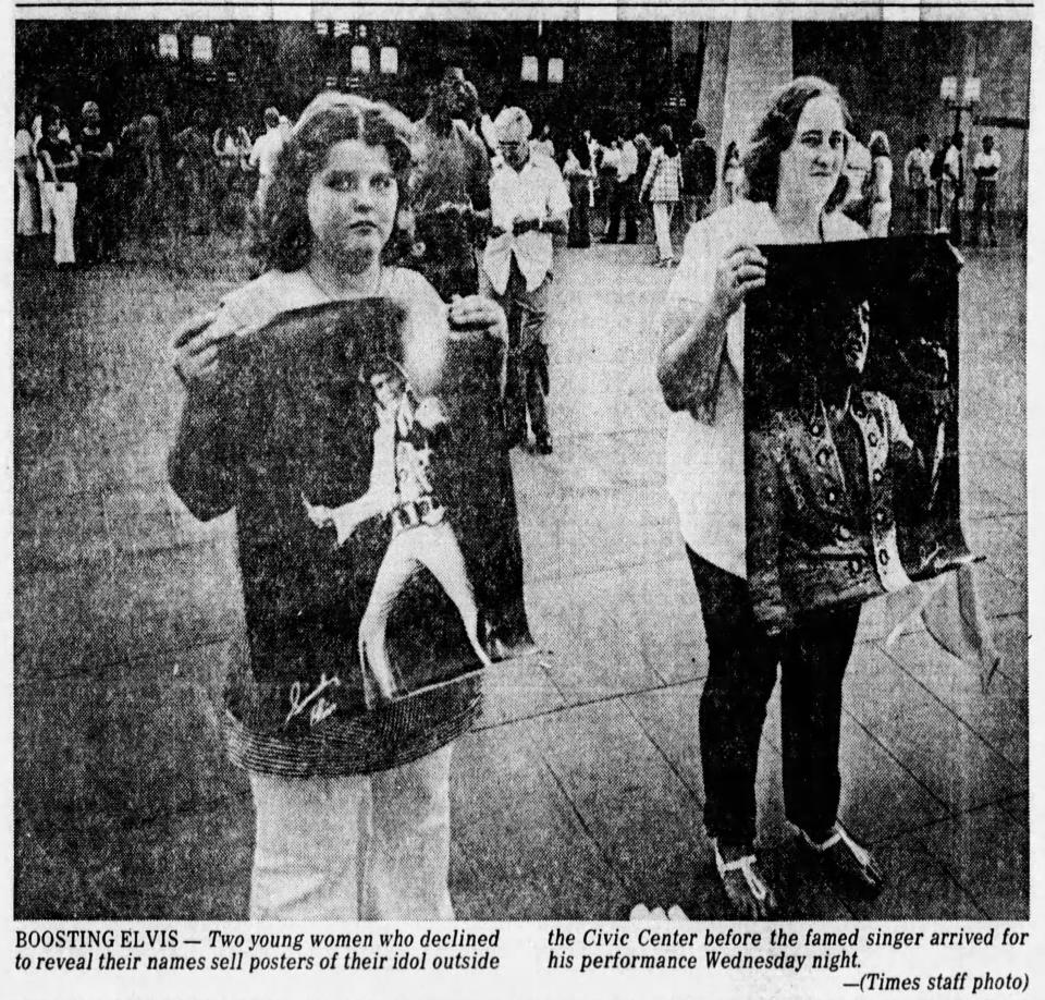 June 3, 1976 Two young women, who decline to reveal their names, sell posters of their idol before the famed singer arrived for his performance.
