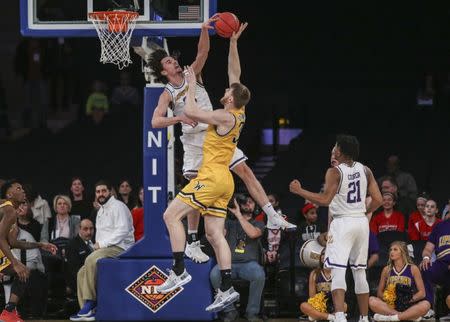 Apr 2, 2019; New York, NY, USA; Lipscomb Bisons forward Eli Pepper (22) blocks the shot of Wichita State Shockers center Asbjorn Midtgaard (33) in the first half of the NIT semifinals at Madison Square Garden. Mandatory Credit: Wendell Cruz-USA TODAY Sports