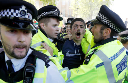 Police officers and demonstrators clash outside Downing Street ahead of the visit by Turkey's President Recep Tayyip Erdogan, in London, Britain, May 15, 2018. REUTERS/Peter Nicholls