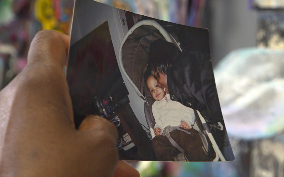 Nadine Young holds a childhood photograph of her granddaughter, Ta'Kiya Young, pictured right, with a younger cousin, at the law offices of the family attorney in Columbus, Ohio, on Wednesday, Sept. 6, 2023. Ta'Kiya Young was shot and killed on Aug. 24 by Blendon Township police outside an Ohio supermarket. The 21-year-old was pregnant and due to give birth in November, according to her family. (AP Photo/Patrick Orsagos)