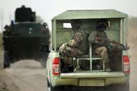 Nigerian soldiers patrol in the north of Borno state on June 5, 2013, close to a former camp near the city of Maiduguri run by Islamist extremist group Boko Haram