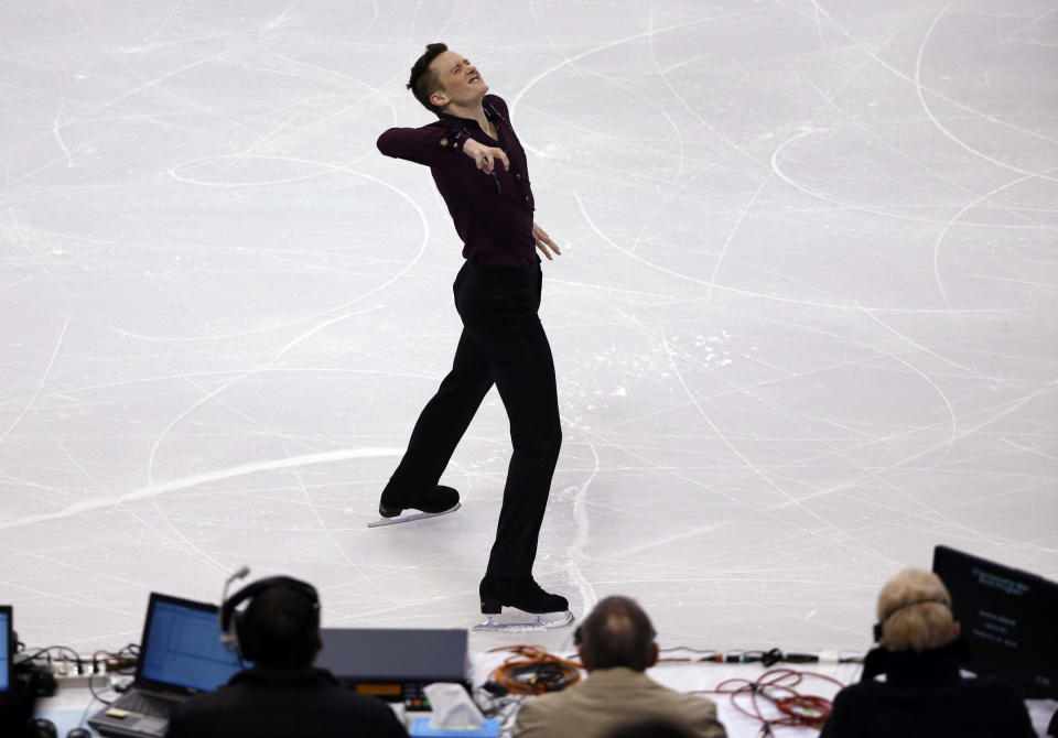 Jeremy Abbott reacts in front of the judges' table at the end of his men's short program at the U.S. Figure Skating Championships in Boston, Friday, Jan. 10, 2014. (AP Photo/Elise Amendola)