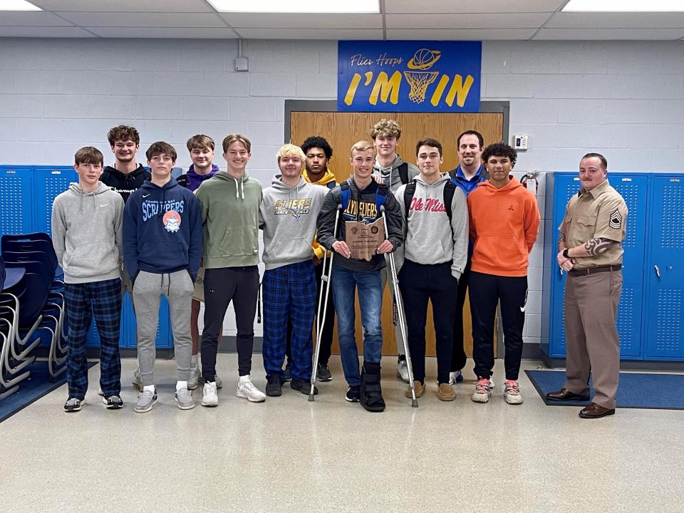 The Clyde Boys Basketball team received second place Academic Honors. In front, left to right, Brayden Olson, Brennan Wilson, Andrew Kauble, Griffin Noftz, Dillon Liskai, Jaden Cook, Kaiden Olson, and Master Sgt. Nick Wright. In back: Adam Kauble, Abe Morrison, Jarrin Bulger, Grant McMaster, and Coach Ryan Fretz. Not Pictured: Brady Wilson, Kyle Flewelling, Cole Schwochow, Coach Blayze Behney, Coach Ron Meade, and Coach Collin Rieman.