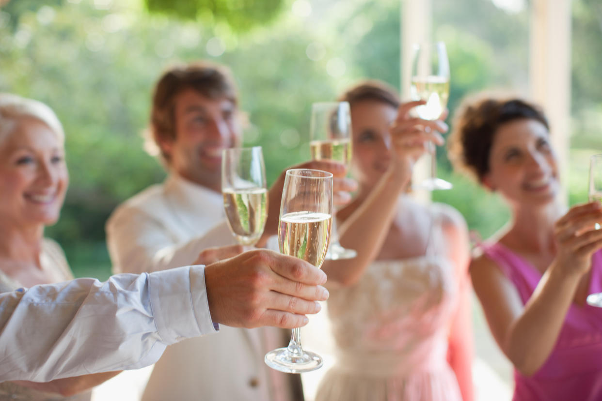 Wedding guests have to cover expenses like accommodation and travel, so many don't expect to also have to pay for drinks on the big day. (Getty Images)