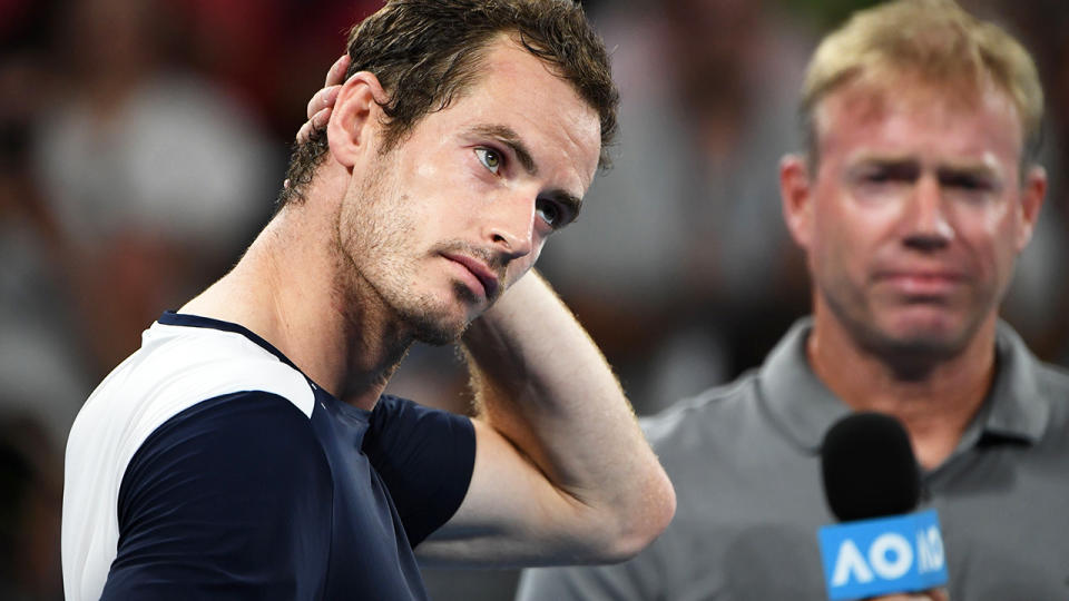 Andy Murray looked a bit awkward as the montage played. (Photo by SAEED KHAN/AFP/Getty Images)