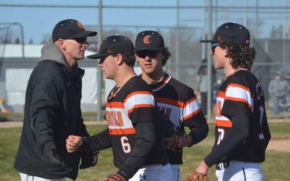 Cheboygan varsity baseball coach Kevin Baller congratulates players during a game from this past season. Baller guided the Chiefs to one of their best seasons in program history this past spring. The Chiefs won a school record 30 games, while also capturing conference and district titles.