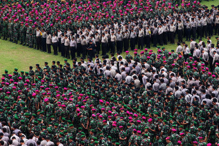 Indonesian military and police personnel attend a security briefing ahead of Jakarta's gubernatorial election in Jakarta, Indonesia April 18, 2017 in this photo taken by Antara Foto. Antara Foto/Rivan Awal Lingga/via REUTERS