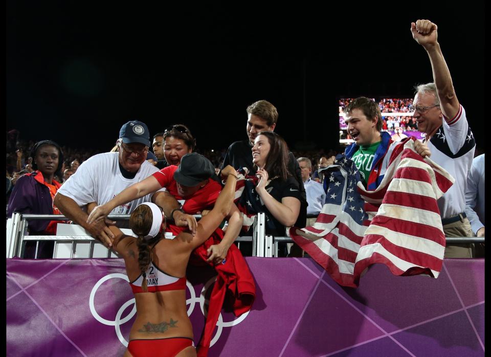 United States' Misty May-Treanor celebrates with her fans and friends after winning the women's gold medal beach volleyball match at the 2012 Summer Olympics, Wednesday, Aug. 8, 2012, in London. 