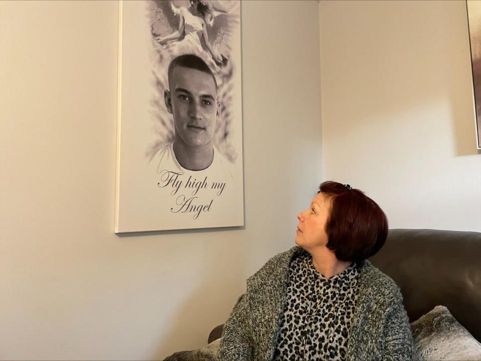 Sharon Hendry looks up at a canvas picture of her son Ben (The Independent)