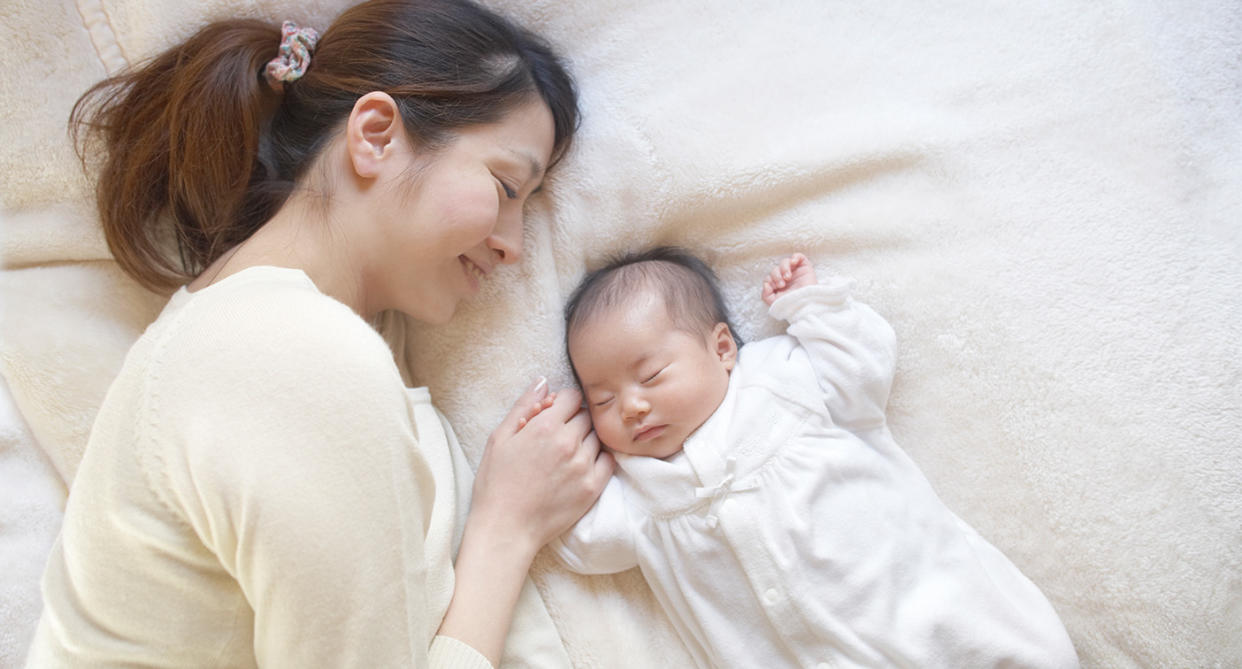 Mum sleeping with baby. (Getty Images)