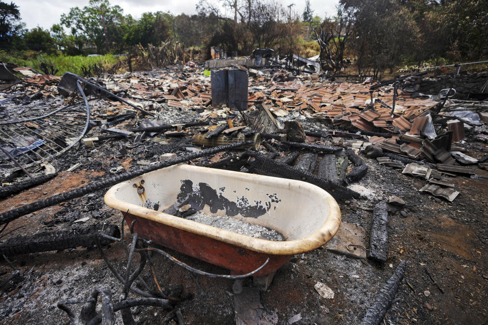 FILE - A tub rests in the middle of a wildfire-destroyed home, Monday, Aug. 14, 2023, in Kula, Hawaii. The Maui Fire Department is expected to release a report Tuesday, April 16, 2024, detailing how the agency responded to a series of wildfires that burned on the island during a windstorm last August. (AP Photo/Rick Bowmer, File)