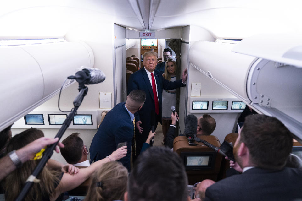 President Donald Trump talks with reporters after leaving a campaign rally at Pensacola International Airport, Friday, Oct. 23, 2020, aboard Air Force One. (AP Photo/Evan Vucci)