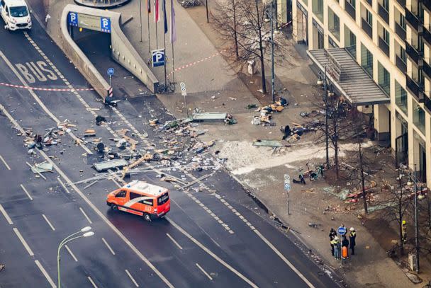 PHOTO: Debris covers the street in front of a hotel after an aquarium burst inside the hotel in Berlin, Dec. 16, 2022. (Christoph Soeder/DPA via AP)