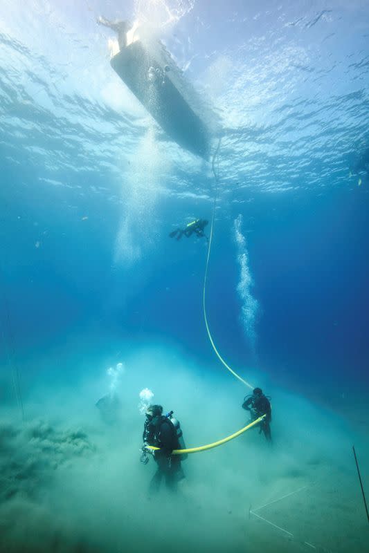 Divers investigate one of the many anomalies discovered during the magnetometer survey of the waters thought to contain the remains of Hernan Cortes' scuttled fleet of 1519, at the littoral of Veracruz state