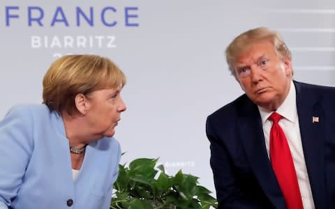 U.S. President Donald Trump meets German Chancellor Angela Merkel for bilateral talks during the G7 summit in Biarritz, - Credit: REUTERS