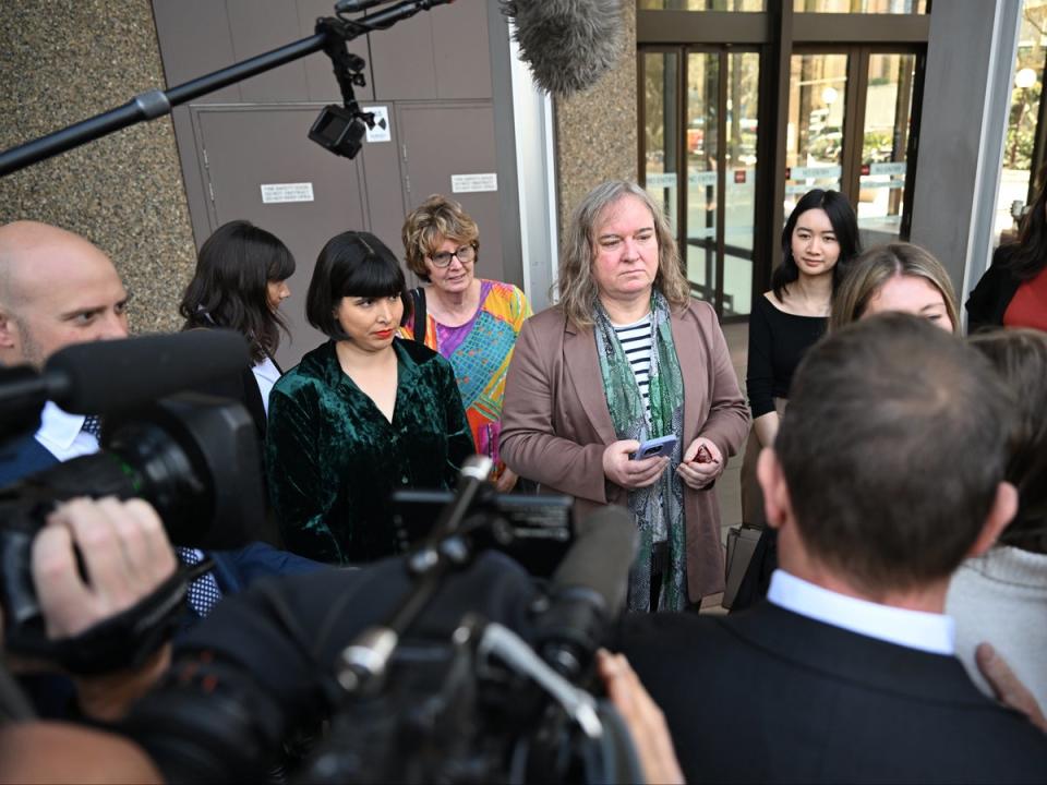 Roxanne Tickle (centre) speaks to the media as she leaves the Federal Court of Australia in Sydney, Australia, 23 August 2024 (EPA)