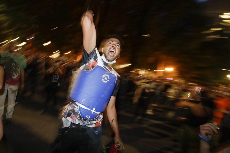 A demonstrator yells out slogans during a Black Lives Matter protest at the Mark O. Hatfield United States Courthouse Wednesday, July 29, 2020, in Portland, Ore. (AP Photo/Marcio Jose Sanchez)