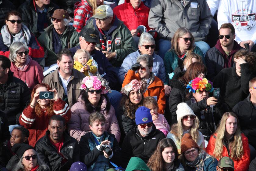 Pasadena, CA - January 02: Thousands of parade-goers watch the 2023 Tournament of Roses Parade on Orange Grove Blvd., just before turning onto Colorado Blvd. in Pasadena Monday, Jan. 2, 2023. "Turning the Corner" was this year's theme. (Allen J. Schaben / Los Angeles Times)