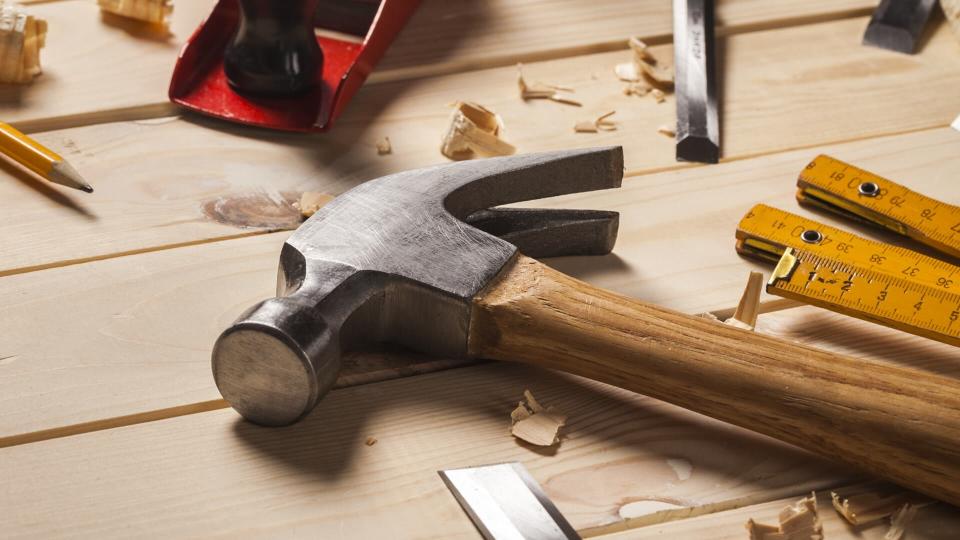 hammer and other hardware tools on wooden deck