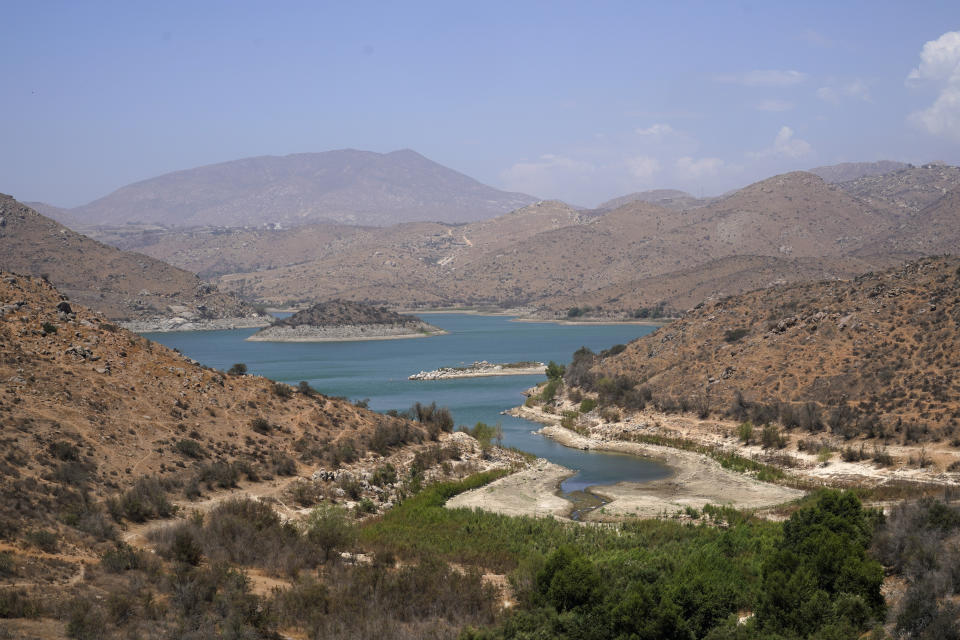 Low water levels are visible at the El Carrizo reservoir Monday, Aug. 15, 2022, in Tijuana, Mexico. Steep water cuts to U.S. states using Colorado River water are looming, which means that Mexico could face more cuts, too. (AP Photo/Gregory Bull)
