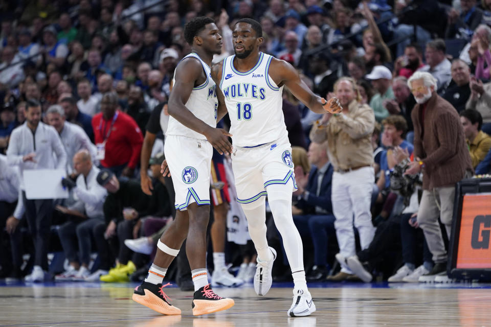 Minnesota Timberwolves guard Shake Milton (18) celebrates with guard Anthony Edwards (5) after making a basket during the first half of an NBA basketball game against the New Orleans Pelicans, Wednesday, Nov. 8, 2023, in Minneapolis. (AP Photo/Abbie Parr)