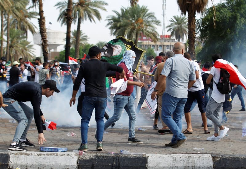 Demonstrators disperse as Iraqi Security forces use tear gas during a protest over corruption, lack of jobs, and poor services, in Baghdad