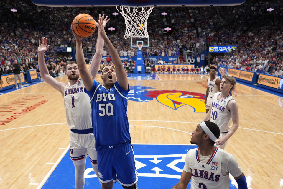 BYU center Aly Khalifa (50) shoots during the second half of an NCAA college basketball game against Kansas Tuesday, Feb. 27, 2024, in Lawrence, Kan. BYU won 76-68. (AP Photo/Charlie Riedel)