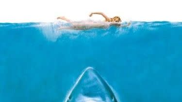 the poster for the classic horror movie jaws, which features a shark under a swimming woman