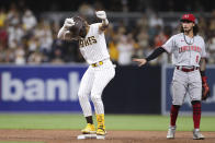 San Diego Padres' Fernando Tatis Jr., left, dances at second base in front of Cincinnati Reds' Jonathan India (6) after hitting a double during the third inning of a baseball game Friday, June 18, 2021, in San Diego. (AP Photo/Derrick Tuskan)