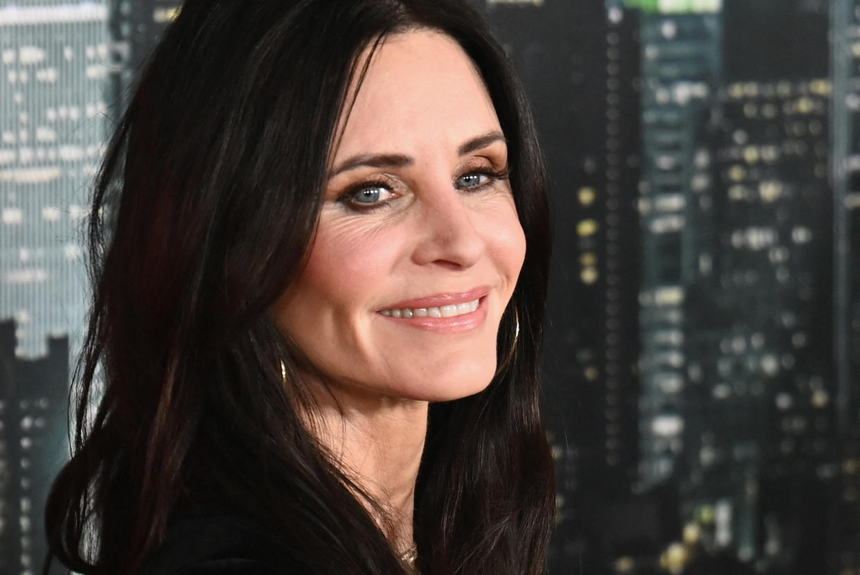 Courteney Cox smiles at the cameras as she arrives for the world premiere of 