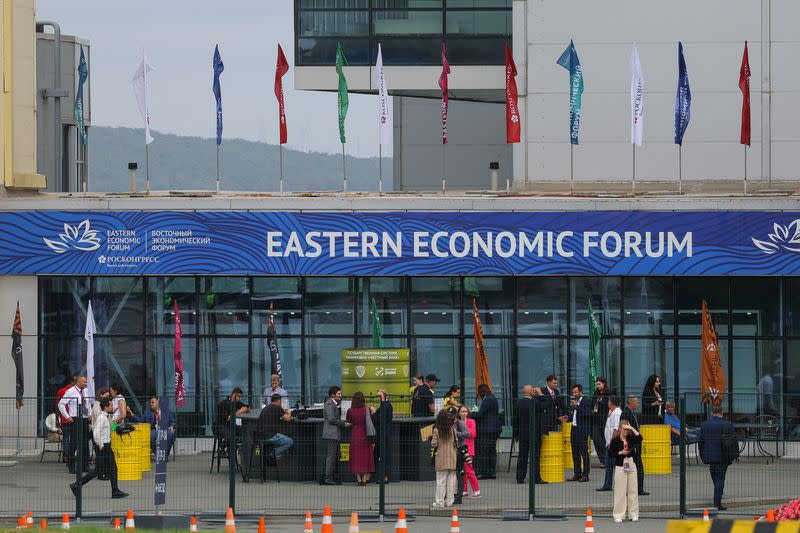 People stand at the entrance to the Far Eastern Federal University on Russky Island, venue of the Eastern Economic Forum 2023 in Vladivostok