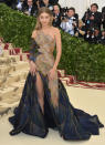 <p>The model paired an old Hollywood glam hairstyle with a mosaic-inspired Versace gown. (Photo: Getty Images) </p>