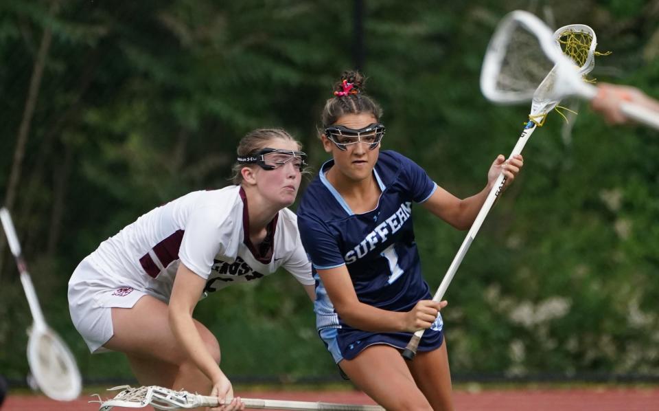 Suffern's Michaela Fay (1) works against Kingston's Katerina Deising (5) in the Class A state regional final girls lacrosse game at James I. O'Neill High School in Highland Falls on Saturday, June 3, 2023. Fay, who received all-star honors last year as a freshman, will be back at midfield for the Mounties. 
(Credit: John Meor