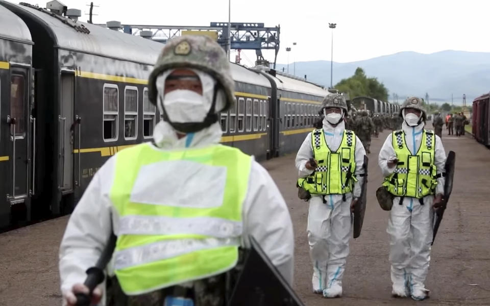 In this handout photo taken from video released by Russian Defense Ministry Press Service on Monday, Aug. 29, 2022, Chinese soldiers arrive to the Grodekovo railway station to participate in war games drills, in Grodekovo, Primorsky Krai, Russia. Russia said Monday it will launch sweeping war games drills in the country's east that will involve forces from China — a show of increasingly close military ties between Moscow and Beijing amid tensions with the West over the Kremlin's action in Ukraine. (Russian Defense Ministry Press Service via AP)