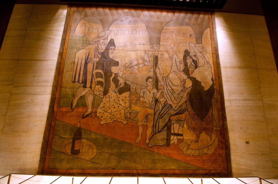 In this Feb. 28, 2014, photo provided by the New York Landmarks Conservancy, a stage curtain painted by Pablo Picasso hangs on a wall at the Four Seasons restaurant in New York. Plans to move the 1919 canvas from the Four Seasons has touched off a dispute between a prominent preservation group against an art-loving real estate magnate. (AP Photo/New York Landmarks Conservancy, Rick Bruner)