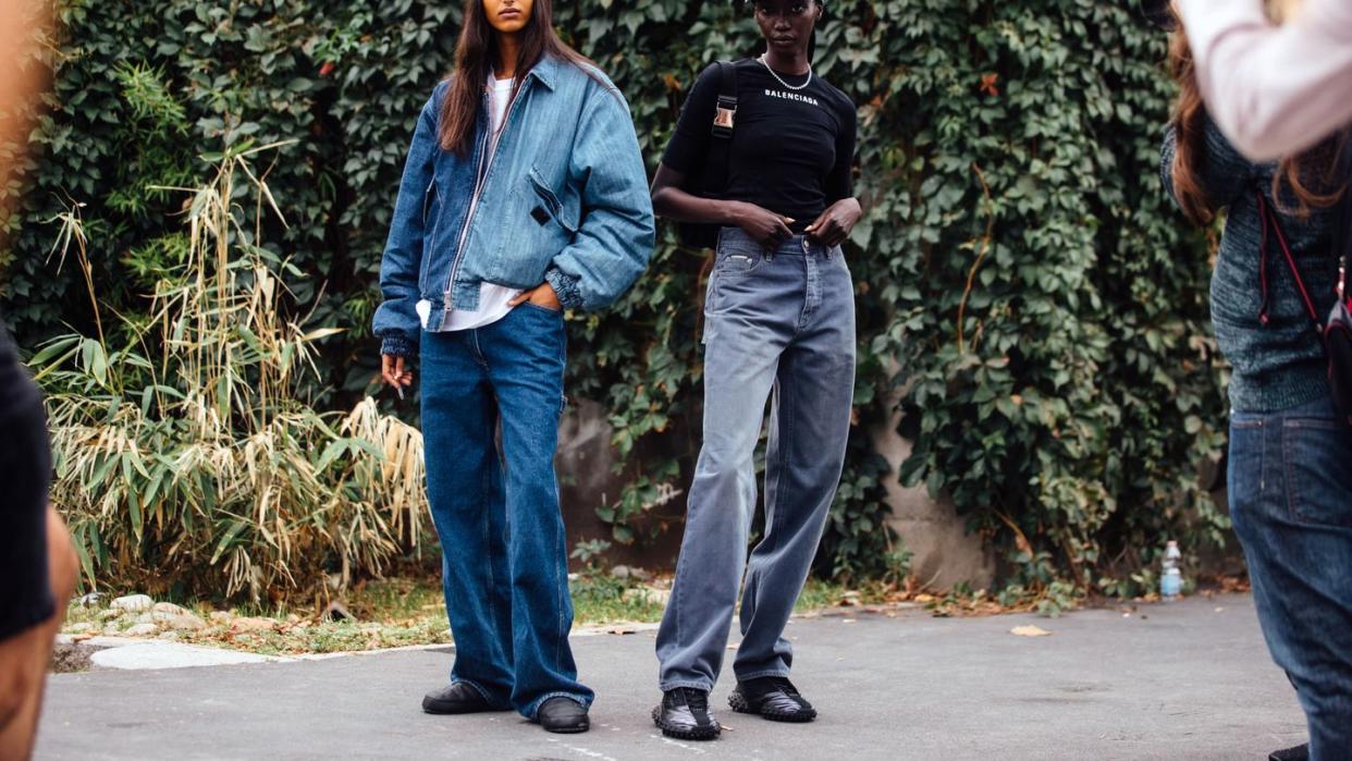 two models at milan fashion week wear head to toe denim outfits to illustrate a story about sustainable denim