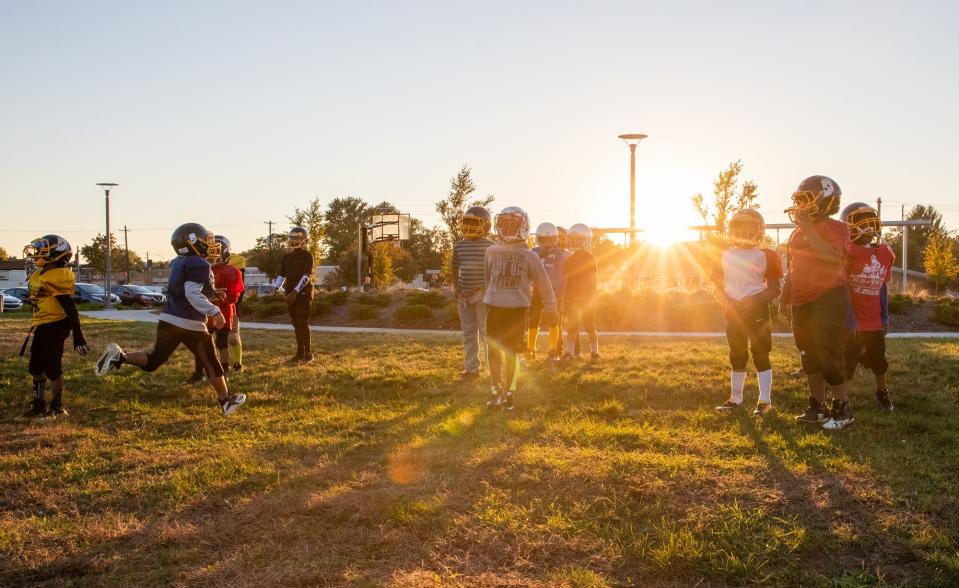 The Indy Steelers practice as the sun sets at Tarkington Park. Coach Nell Hamilton grew up in the Butler-Tarkington neighborhood and founded the Indy Steelers.