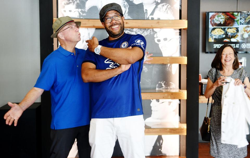 Wendell Riley gets a kiss from a patron as he gets photographed on August 4, 2023. Riley just finished his first year as Robertson Film Center's executive director.