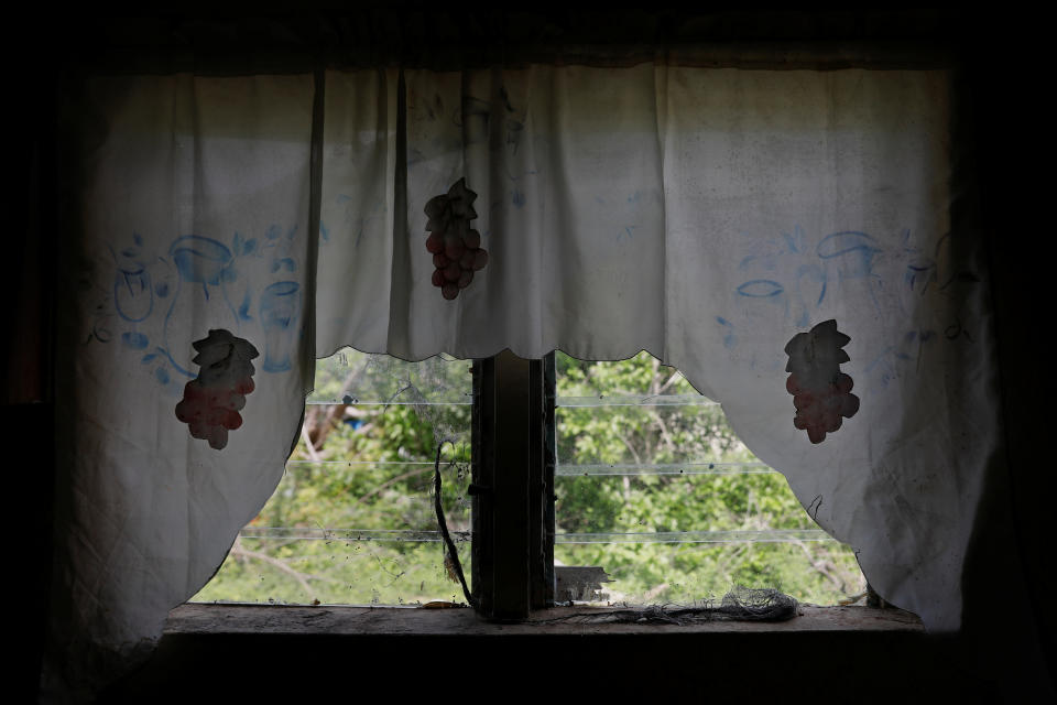 Curtains are seen hanging from a home at Codrington on the island of Barbuda just after a month after Hurricane Irma struck the Caribbean islands of Antigua and Barbuda