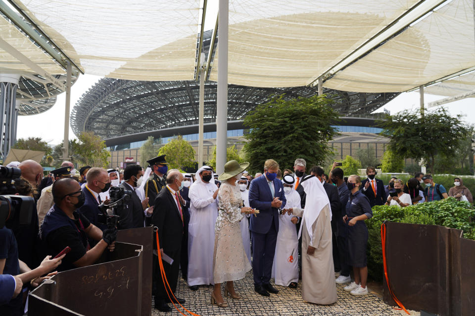 Queen Maxima, King Willem-Alexander and Emirati Tolerance Minister Sheikh Nahyan bin Mubarak Al Nahyan watch as a pair of scissors falls to the ground after cutting a ribbon at the Netherlands pavilion at Expo 2020 in Dubai, United Arab Emirates, Wednesday, Nov. 3, 2021. King Willem-Alexander and Queen Maxima of the Netherlands are in the United Arab Emirates as part of a royal trip to the country to visit Dubai's Expo 2020. (AP Photo/Jon Gambrell)